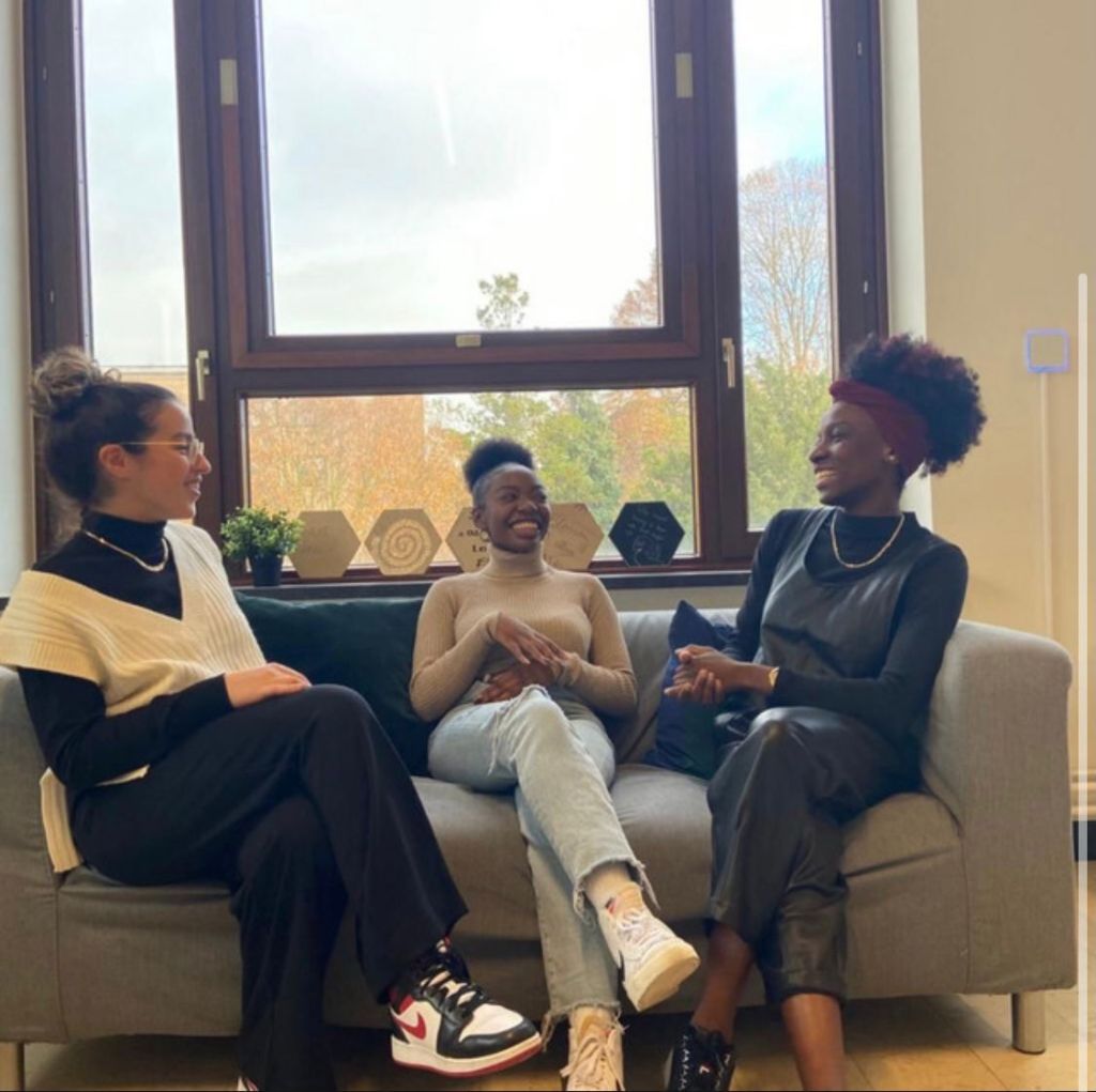 Foto: drie mensen zitten samen in een zetel. Afbeelding van de eerste podcast. 